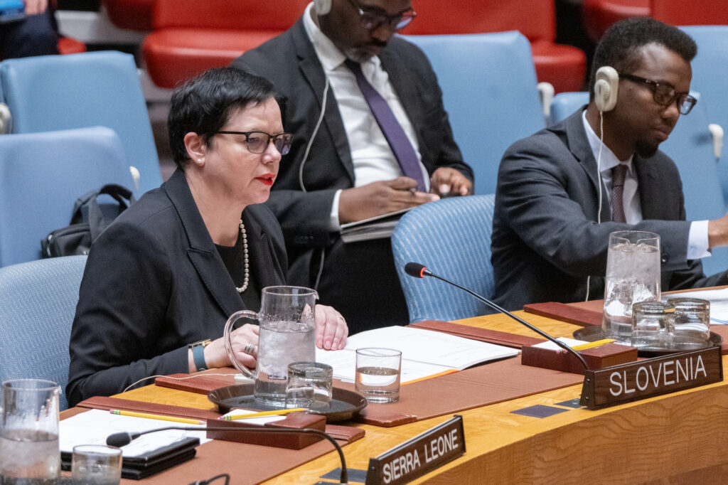Ms. Ondina Blokar Drobič sitting at a table and delivering Slovenian statement, surrounded by other people